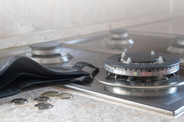 The energy crisis. An empty wallet lies on a disconnected gas cooker. The high cost of gas.