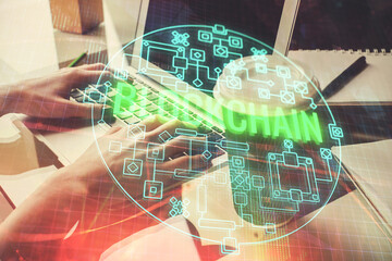 Double exposure of woman hands typing on computer and crypto market theme hologram drawing. Blockchain concept.