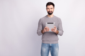 Photo of young handsome man good mood use tablet device chief boss isolated over grey color background