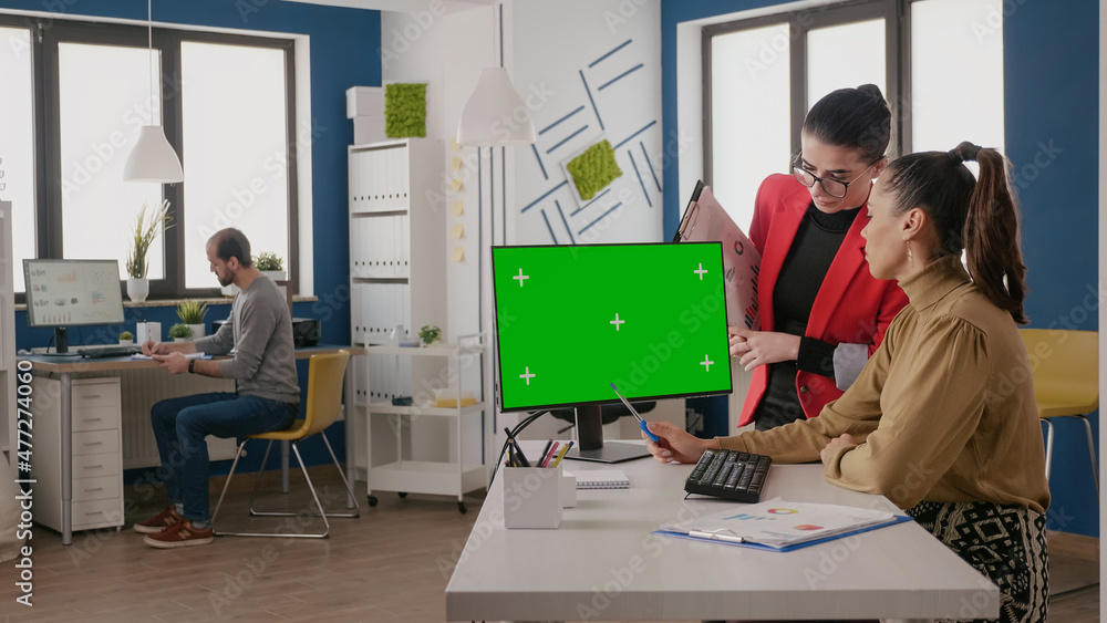 Poster team of colleagues using green screen on computer in business office. coworkers looking at chroma ke