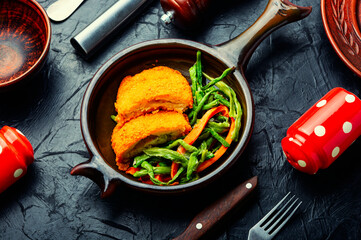 Chicken cutlets and vegetable garnish.