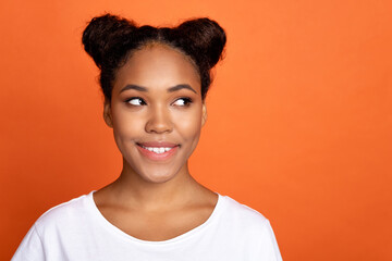 Photo of young cheerful lady interested look empty space minded smart isolated over orange color...