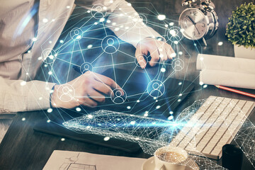 Double exposure of man's hands holding and using a phone and social network theme drawing.