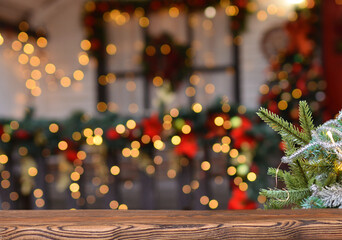 Christmas background. Empty wooden board on background of blurred christmas house outdoors and New...