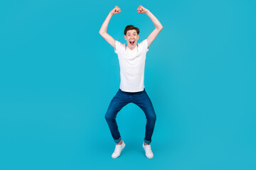 Fototapeta premium Full body photo of young excited man good mood rejoice victory triumph success isolated over blue color background