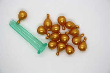 A jar for facial massage and gold capsules with oil.