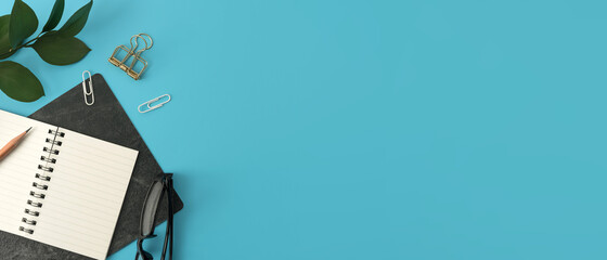 Styled stock photography blue office desk table with blank notebook, keyboard, macaroon, supplies and coffee cup. Top view with copy space. Flat lay.