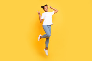 Fototapeta na wymiar Full size photo of young african woman have fun jump show fingers peace v-symbol isolated over yellow color background