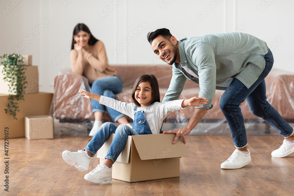 Sticker happy middle eastern family celebrating moving day in new apartment