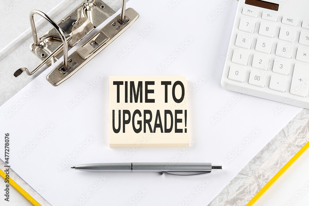 Poster time to upgrade - business concept, message on the sticker on folder background with calculator