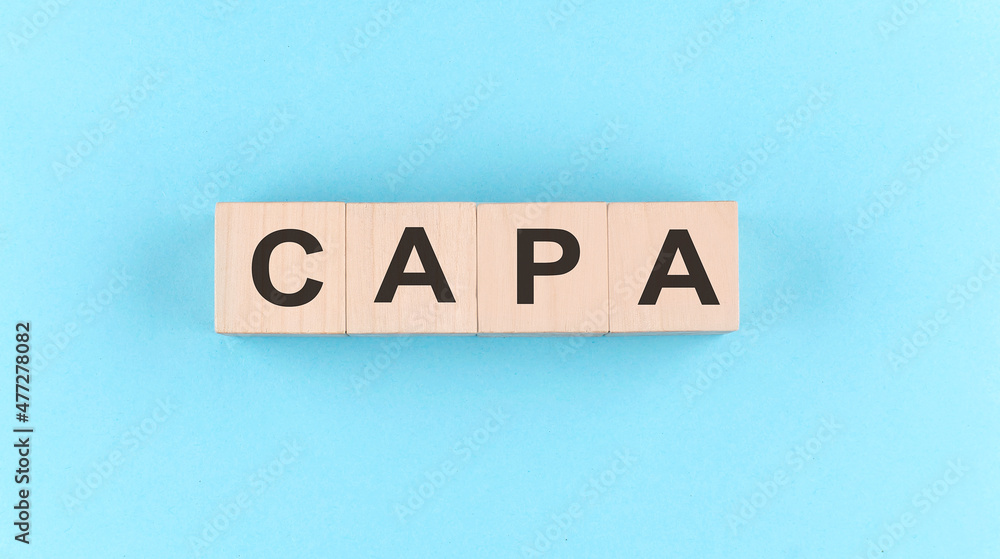 Poster wooden cube block with text capa on the blue background