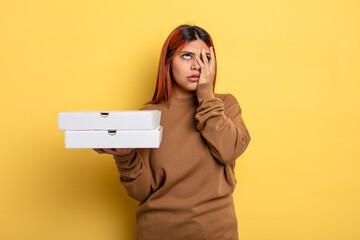 hispanic woman feeling bored, frustrated and sleepy after a tiresome. take away pizzas concept