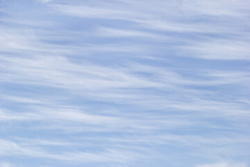 Texture white cirrus clouds on the background blue sky.