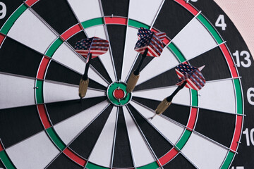 Concept of competition and goal achievement.Achieving goals in business and life.Dartboard with three darts stuck right center of target.