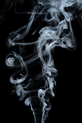 Clouds of curls of smoke on a black background.