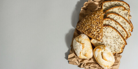 Freshly baked bread, buns, and toasts. Parchment, trendy hard li