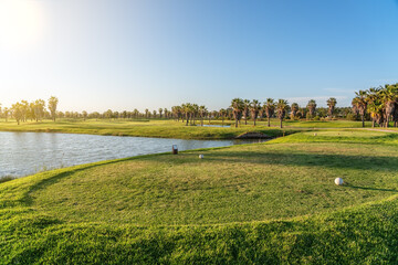 Obraz premium Modern golf courses for tourists with clear ponds and palm trees for relaxation and golf. Albufeira, Algarve