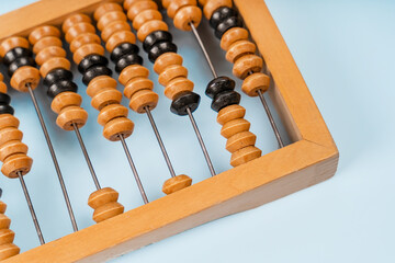 Wooden old abacus on a blue background. Flat lay and top view. Business or accounting concept - obrazy, fototapety, plakaty