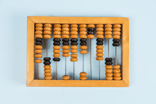 Wooden old abacus on a blue background. Flat lay and top view. Business or accounting concept