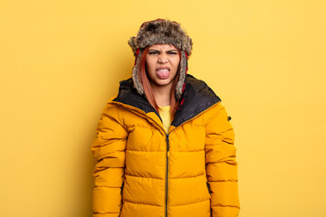 hispanic woman feeling disgusted and irritated and tongue out. winter concept