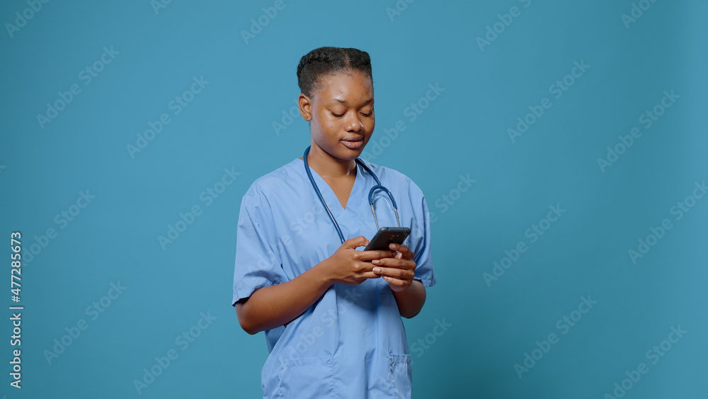 Aufkleber portrait of medical assistant using smartphone with touch screen to work on expertise and to practic