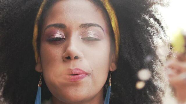 Carnival Party in Brazil, brazilian woman blowing confetti at parade festival dressed