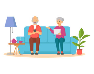 Elderly man and woman surfing internet together. Happy old couple watching video on tablet pc and smartphone. Grandparents sitting with gadget in living room. Elderly people are using technologies