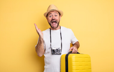 middle age man tourist feeling happy and astonished at something unbelievable. travel concept
