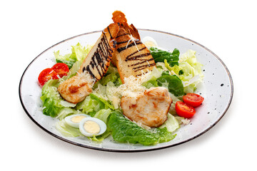 Caesar salad with chicken on a white decorative plate. A classic salad.