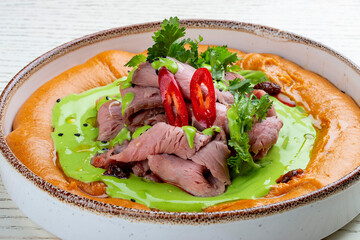 Hummus with veal sous-vide and parsley cream.