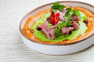 Hummus with veal sous-vide and parsley cream.