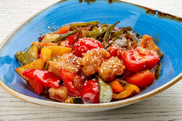 Asian-style chicken with sweet and sour sauce and vegetables.