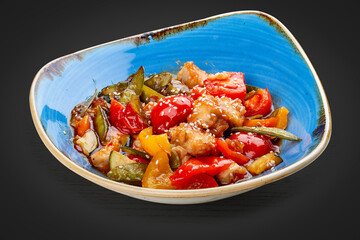 Asian-style chicken with sweet and sour sauce and vegetables.
