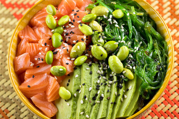 Delicious poke bowl placed on table