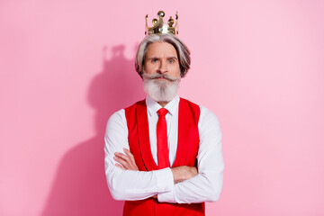 Portrait of attractive serious content grey-haired man wearing retro vest crown folded arms isolated over pink pastel color background © deagreez