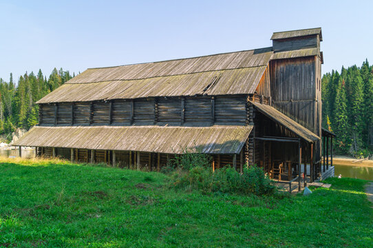 An old wooden complex of the salt industry, built in the 19th century. Salt factory. Wooden salt storage building. Wooden large old buildings made of logs.