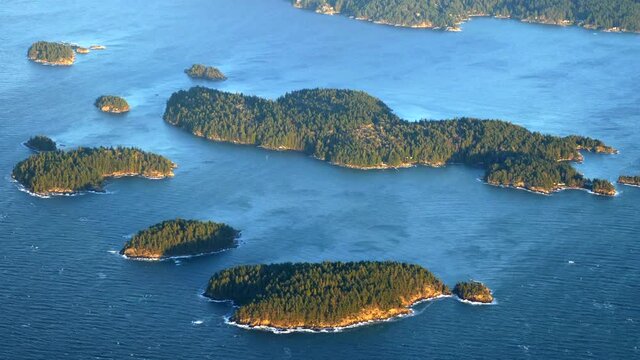 Small Pine Tree Forested Islands in the Ocean, Aerial View Golden Hour