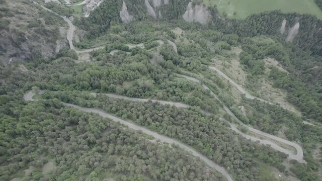 panning video with drone over the aosta valley in saint nicolas with the church of fonfo and over a winding road