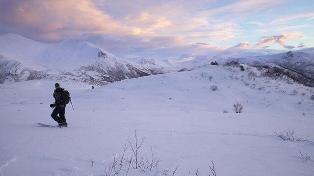 Splitboarder morning hiking in mountain
