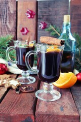 Cups with mulled wine, Christmas decorations, fir branches on a wooden background, the concept of home comfort, winter holidays celebration