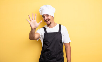 chef man smiling and looking friendly, showing number five