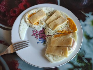 Scrambled eggs with pieces of cheese on a plate