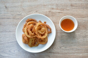 batter fried onion ring on plate dipping chili sweet sauce