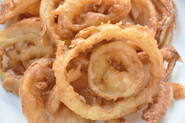 batter fried onion ring on plate dipping chili sweet sauce