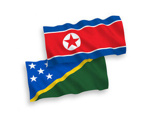 National vector fabric wave flags of North Korea and Solomon Islands isolated on white background. 1 to 2 proportion.
