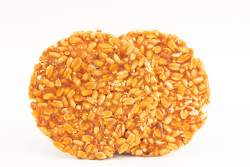 Makar Sankranti Or Lohri Mithai Badam Chikki Also Known As Kozinaki, Gud Singdana Chikky, Gud Patti Or Gur Papadi Made Of Sesame, Nuts Groundnut Mungfali And Jaggery Gur. Isolated On White Background