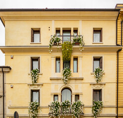 Fototapeta na wymiar View on a yellow building in Treviso - Italy