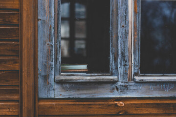 Obraz na płótnie Canvas books located on the windowsill outside the window, with a blue frame 