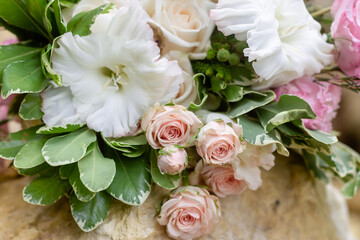 Beautiful bouquet of flowers in pastel colors close-up. Wedding traditions concept. Blurred background. Selective focus.
