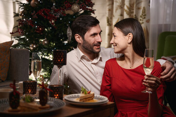 Happy man and woman enjoying the celebration of Christmas together